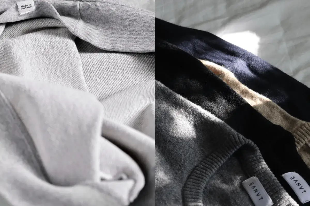Graue Stoffe, ein Pullover aus Baumwolle und ein weiterer aus Wolle, zeigen den Unterschied in Textur und Glanz.
